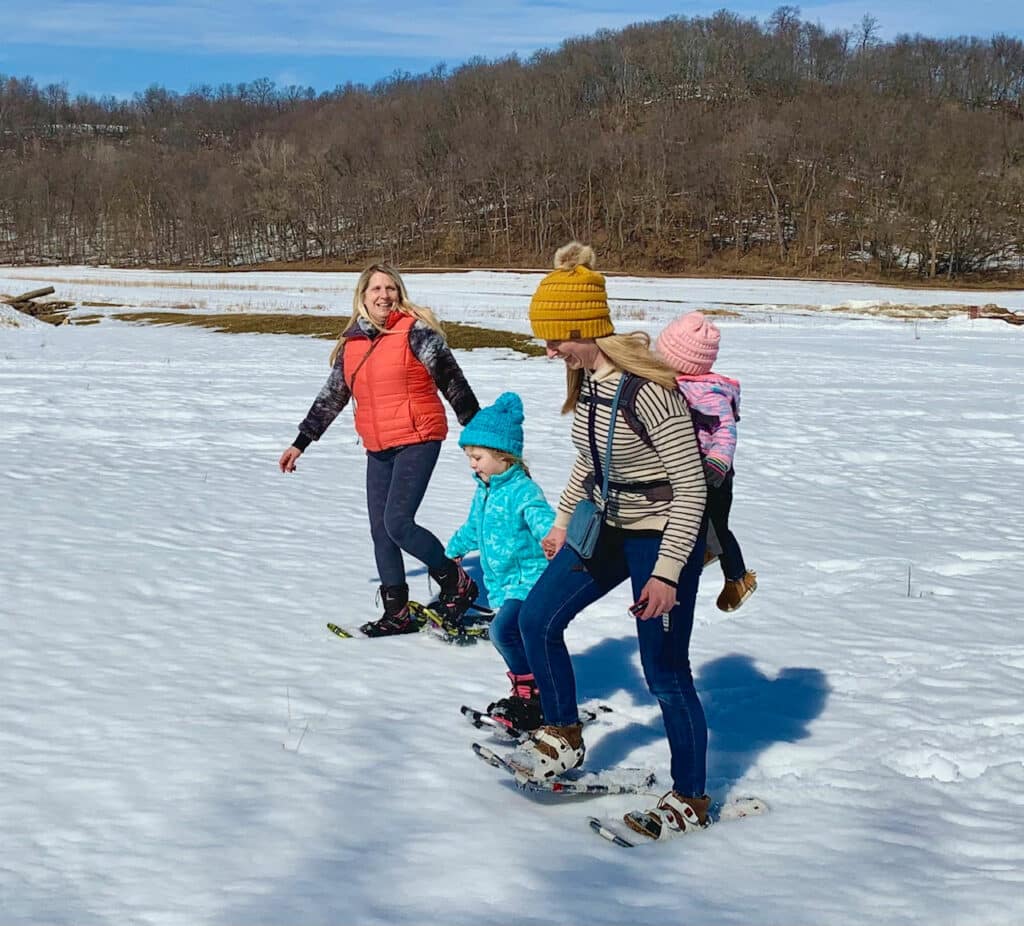 Kristie, her daughter and granddaughters snowshoeing at Justin Trails Resort