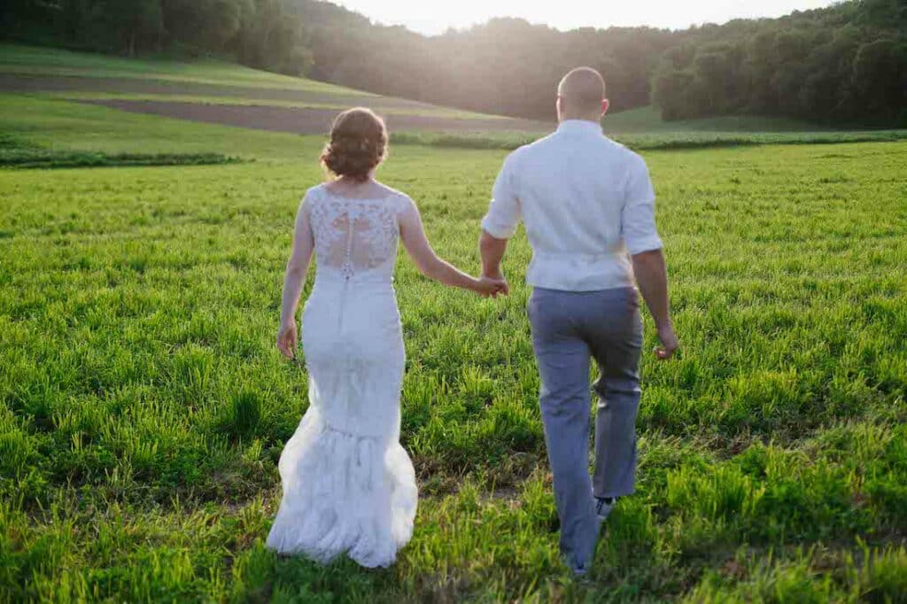 Plan Your Wisconsin Elopement at Justin Trails Resort in 2023, photo of a bride and groom in a big open field